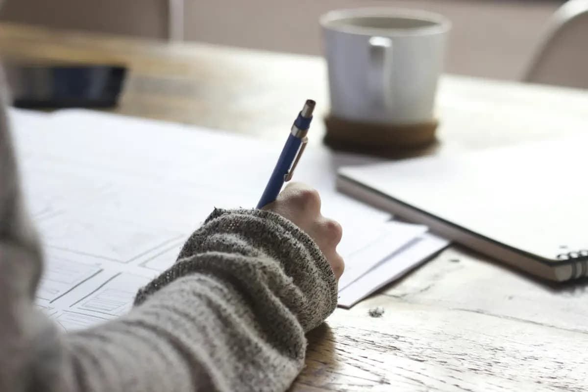A person filling out a questionnaire at their desk
